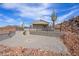 A desert backyard with a tall cactus and rocky landscaping, all surrounded by a black metal fence at 27145 N 147Th Ave, Surprise, AZ 85387