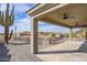 Spacious covered patio features ceiling fans, desert landscaping, and relaxing outdoor living space at 27145 N 147Th Ave, Surprise, AZ 85387