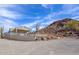 A concrete outdoor area offers views of the mountain behind the home, surrounded by desert foliage at 27145 N 147Th Ave, Surprise, AZ 85387
