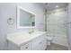Bathroom with a vanity and a framed mirror, along with a bathtub and shower with sliding glass doors at 27145 N 147Th Ave, Surprise, AZ 85387