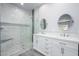 Luxurious bathroom featuring a double vanity, decorative mirrors, and a tiled walk-in shower at 27145 N 147Th Ave, Surprise, AZ 85387