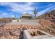 A home with desert landscaping, including a tall saguaro cactus, enclosed by black fencing at 27145 N 147Th Ave, Surprise, AZ 85387