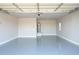 Spacious garage featuring an epoxy floor and a water heater at 27145 N 147Th Ave, Surprise, AZ 85387