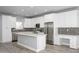 Spacious kitchen featuring a large island, stainless steel appliances, and built-in desk area at 27145 N 147Th Ave, Surprise, AZ 85387