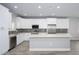 Modern kitchen featuring white cabinets, stainless steel appliances, and a stylish backsplash at 27145 N 147Th Ave, Surprise, AZ 85387