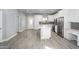 Open kitchen concept with stainless steel appliances, kitchen island, and modern design at 27145 N 147Th Ave, Surprise, AZ 85387