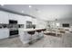 Well-lit kitchen with stainless steel appliances, white cabinets, and breakfast bar seating at 27145 N 147Th Ave, Surprise, AZ 85387