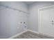 Practical laundry room with installed shelving and utility hookups for appliances at 27145 N 147Th Ave, Surprise, AZ 85387