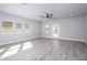 Spacious living room boasting wood-look flooring, ample natural light, a ceiling fan, and neutral paint at 27145 N 147Th Ave, Surprise, AZ 85387