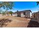 View of the home's exterior and backyard with block fence and plenty of potential for landscaping at 3035 W Pierce St, Phoenix, AZ 85009