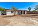 Expansive backyard featuring a covered patio, mature tree, and ample space for outdoor activities at 3035 W Pierce St, Phoenix, AZ 85009