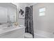 Modern bathroom featuring a marble-patterned shower curtain and a sleek vanity at 3035 W Pierce St, Phoenix, AZ 85009