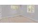 Bright bedroom with windows, neutral walls, ceiling fan, and vinyl flooring at 3035 W Pierce St, Phoenix, AZ 85009
