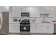 Updated kitchen with stainless steel appliances, gas range, microwave and white cabinets at 3035 W Pierce St, Phoenix, AZ 85009