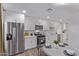 The modern kitchen features stainless steel appliances, white cabinetry, and a stylish eating area at 3035 W Pierce St, Phoenix, AZ 85009