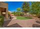 Expansive backyard featuring a lush lawn, mature trees, and a cozy fire pit area for outdoor enjoyment at 3103 S Dakota Pl, Chandler, AZ 85248