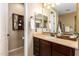 Well-lit bathroom with a single vanity, tile floor, and decorative wall-mounted shelf at 3103 S Dakota Pl, Chandler, AZ 85248