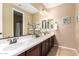 Double sink bathroom with a large mirror, neutral paint, and decorative towel rack at 3103 S Dakota Pl, Chandler, AZ 85248