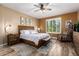 Comfortable bedroom with a wooden bed frame, plantation shutters, and neutral color scheme at 3103 S Dakota Pl, Chandler, AZ 85248