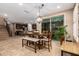 Open dining area showcasing a modern pendant light fixture, direct access to the kitchen, and outdoor views at 3103 S Dakota Pl, Chandler, AZ 85248