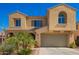 Inviting two-story home with a tan stucco exterior, arched windows, and a well-maintained front yard at 3103 S Dakota Pl, Chandler, AZ 85248