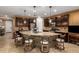 Beautiful kitchen featuring a large island with stone accents and granite countertops, plus dark wood cabinetry at 3103 S Dakota Pl, Chandler, AZ 85248