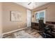 Functional office with a wooden desk, black office chair, and a world map at 3103 S Dakota Pl, Chandler, AZ 85248