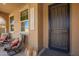 Welcoming front porch with comfortable seating, stylish lanterns, and a secure screen door entry at 3103 S Dakota Pl, Chandler, AZ 85248