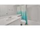 Clean bathroom featuring a shower-tub combo, modern vanity with solid surface countertop, and bright accents at 3349 E Carmel Ave, Mesa, AZ 85204
