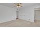 Spacious carpeted bedroom, features neutral walls, and multiple entries to other rooms at 3349 E Carmel Ave, Mesa, AZ 85204