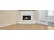 Close-up of the fireplace with white painted brick, wood mantle, and hardwood flooring at 3349 E Carmel Ave, Mesa, AZ 85204