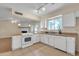 Galley kitchen featuring white appliances, tile flooring and butcher block countertops at 3349 E Carmel Ave, Mesa, AZ 85204