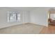 Bright living room with large window, neutral walls and carpet flooring at 3349 E Carmel Ave, Mesa, AZ 85204