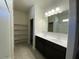 Spacious bathroom featuring dual sinks, dark cabinets, and a large mirror at 36638 W Santa Clara Ave, Maricopa, AZ 85138