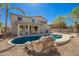 The backyard features a pool with waterfall, patio area, and barbecue - ideal for outdoor entertaining at 3730 E Diamond Ct, Gilbert, AZ 85297