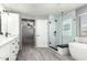 Bathroom featuring a glass shower, soaking tub, and a dual sink vanity at 3730 E Diamond Ct, Gilbert, AZ 85297