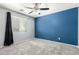 Stylish bedroom featuring carpet, a large window, and bold accent wall for a modern touch at 3730 E Diamond Ct, Gilbert, AZ 85297