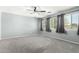 Spacious bedroom with lots of windows, neutral walls, and gray carpet flooring at 3730 E Diamond Ct, Gilbert, AZ 85297