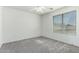 A bedroom with a window, neutral carpet, and ceiling fan offers a serene and comfortable space at 3730 E Diamond Ct, Gilbert, AZ 85297