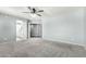 Large bedroom with carpet flooring features ceiling fan and access to a bathroom and walk-in closet at 3730 E Diamond Ct, Gilbert, AZ 85297