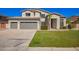 Charming two-story home featuring a well-maintained lawn, mature landscaping, and a spacious three-car garage at 3730 E Diamond Ct, Gilbert, AZ 85297