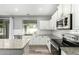 Updated kitchen with granite counters, stainless appliances, and white subway tile backsplash at 3730 E Diamond Ct, Gilbert, AZ 85297