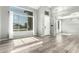 Bright and airy living room with wood-look floors, high ceilings, and large windows at 3730 E Diamond Ct, Gilbert, AZ 85297
