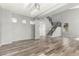 Spacious living area with wood-look floors, modern lighting, and an open staircase with iron railings at 3730 E Diamond Ct, Gilbert, AZ 85297