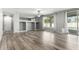 Open-concept living room with wood-look floors, built-in shelving, and sliding glass doors to the backyard at 3730 E Diamond Ct, Gilbert, AZ 85297