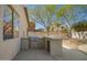 Outdoor kitchen features a stainless steel grill, concrete counter, and ample space for entertaining in the backyard at 3730 E Diamond Ct, Gilbert, AZ 85297
