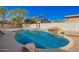 Backyard offers a beautiful private pool with rock details and a boulder feature, surrounded by desert landscaping at 3730 E Diamond Ct, Gilbert, AZ 85297