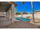Enjoy the backyard's pool with rock features, palm trees and the back patio that is perfect for entertaining at 3730 E Diamond Ct, Gilbert, AZ 85297