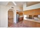 Kitchen featuring stainless steel refrigerator, ample cabinet space, and arched entryways at 4080 W Orchid Ln, Chandler, AZ 85226