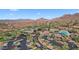 Panoramic aerial view of the community showcasing the golf course, clubhouse, pool, and mountain views at 42047 N Moss Springs Rd, Anthem, AZ 85086